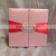Hot sale luxurious pink silk hardcover wedding invitations with red ribbons&rhinestone brooches