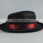Black cowboy hat setting cap with red ribbon