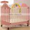 Hot sale small wheels baby wooden nursing bed room furniture kid bed with baby rattle toys