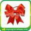 Red satin ribbon bow with elastic loop