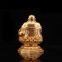 The golden happy buddha stuatue is seated in a double lotus base show his smiling and big belly