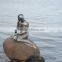 Famous bronze mermaid sculpture by the sea