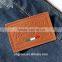Sewn on debossed leather badge for women tote bag