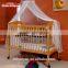 Hot sale small wheels baby wooden nursing bed room furniture kid bed with baby rattle toys