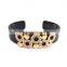 featuring gold plated detail and loop design open bangle