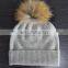 flat knit cashmere beanie hat with raccoon fur pompoms