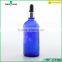 blue essential oil glass bottle with silver dropper