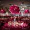 Centerpiece flower arrangement with white orchids cascading over the side, dripping crystal beads and roses