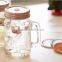 Embossed glass mason jar with lid and handles hot sale