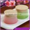 Empty coloured glass cosmetic jars with imitation wood-grain cap