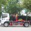 Hook arm garbage truck