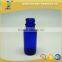 1/2 oz blue glass boston round bottle with black phenolic cap