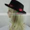 Black cowboy hat setting cap with red ribbon