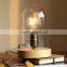 Decorative indoor cloche table light with Edison filament bulbs