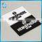 Black-white silicon plastic tag with prominent letters logo for leather gloves