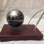 Rectangle red wooden base floating globe with a pen