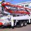 Truck-mounted concrete conveying pump