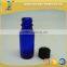 1/2 oz blue glass boston round bottle with black phenolic cap
