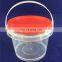 Transparent 500ml plastic bucket with lid and handle.