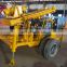 Earth auger water well drilling rig