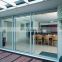 Three track safety glass aluminum sliding doors with mesh screen