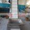 Material handling bucket conveyor with side guard and flight