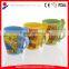 coloured ceramic coffee mug with design printing and spoon in handle