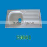 Countertop Above White Acrylic Kitchen Sink With Draining Board