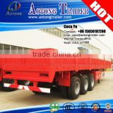 Tri-axis 40ft flat bed cargo transporting side breast board trailer truck with container locks