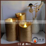 Luminara wick candles with metallic gold color and textured finish