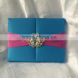 Silk Wedding Invitation with custom brooch closure and foil printed invitations with burgundy ribbon