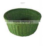 green rattan bowl holding fruit