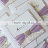 Hot sale & new arrival romantic & elegant white folded embossed wedding invitations with purple ribbons & crystal decorations                        
                                                Quality Choice