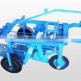 Walk Behind Tractor Attached to a Potato Harvester