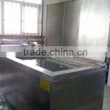 Ultrasonic industrial washing machine for stamped parts