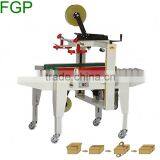 FXJ-5050 Top & Bottom Drive Paper Carton Automatic Adhesive Tape Sealing Machine thumbnail-1
