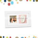 Cute baby photo frame with handprint clay toy