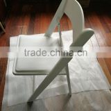 Wholesale white resin folding chair/plastic chair with padded seat