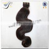 Wholesale grade 7a body wave natural color virgin indian hair curly tape hair extensions