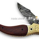 A HANDMADE ENGRAVED BRASS BOLSTERS WITH BROWN G-10 HANDLE, DAMASCUS STEEL LINER LOCK FOLDING KNIFE thumbnail-1