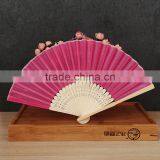 Factory Direct Bamboo Hand Fan Wedding Gift Cloth Folding Hand Fan in Plain Color thumbnail-2