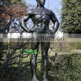 Bronze naked male statue in garden
