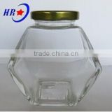 holding 250g Honey glass jar with golden lid