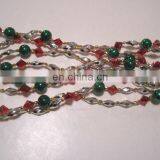 9 FOOT RED, GOLD, SILVER, AND GREEN STRUNG BEAD GARLAND