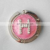 letter series metal enamel round shaped custom handbag hooks with shiny stone