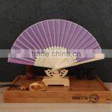 Factory Direct Bamboo Hand Fan Wedding Gift Cloth Folding Hand Fan in Plain Color thumbnail-3