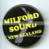 Pin button badge with black background and yellow letter