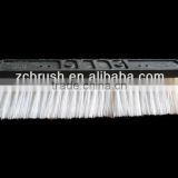 Water flow cleaning brush for glass