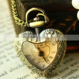 Cutting transparent glass heart shaped old pocket watch