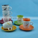 White outside anf colorful inside ceramic coffee cup with saucer